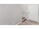 Hallway featuring gray wood-look floors leading to a staircase and a white door at 4490 Rabnor Cir, Las Vegas, NV 89115