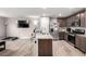 Kitchen featuring gray wood-look floors and an island with granite countertops at 4490 Rabnor Cir, Las Vegas, NV 89115