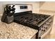 Close up of the stainless steel gas range and granite counters at 4490 Rabnor Cir, Las Vegas, NV 89115