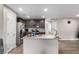 Bright kitchen features a granite island, stainless steel appliances, and modern lighting at 4490 Rabnor Cir, Las Vegas, NV 89115