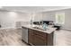 Kitchen island with granite countertops and stainless steel dishwasher offers a seamless flow into the living space at 4490 Rabnor Cir, Las Vegas, NV 89115