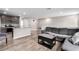 Open-concept living and kitchen area featuring modern finishes and durable plank flooring at 4490 Rabnor Cir, Las Vegas, NV 89115