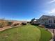 The backyard features a green artificial turf putting green with desert landscaping around the border at 2710 Mustang Pass St, Laughlin, NV 89029