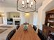 Bright dining room with fireplace, a chandelier and open floorplan at 2710 Mustang Pass St, Laughlin, NV 89029