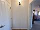 Hallway view towards a bedroom with a bed, carpet, and a ceiling fan at 2710 Mustang Pass St, Laughlin, NV 89029