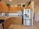 Well-lit kitchen featuring wooden cabinets and stainless steel appliances at 2710 Mustang Pass St, Laughlin, NV 89029