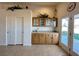 Bright kitchen featuring wooden cabinets and a double door leading to the backyard at 2710 Mustang Pass St, Laughlin, NV 89029