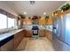 Well-lit kitchen featuring wooden cabinets and stainless steel appliances at 2710 Mustang Pass St, Laughlin, NV 89029