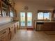 Bright kitchen featuring wooden cabinets, stainless steel appliances, and a double door leading to the backyard at 2710 Mustang Pass St, Laughlin, NV 89029