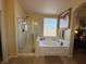 Bright bathroom featuring a glass shower, tub, and accent lighting at 2710 Mustang Pass St, Laughlin, NV 89029