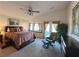 Spacious main bedroom featuring a ceiling fan, reading chair, and a bay window with curtains at 2710 Mustang Pass St, Laughlin, NV 89029