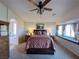 Spacious main bedroom featuring a ceiling fan and a bay window with curtains at 2710 Mustang Pass St, Laughlin, NV 89029