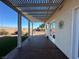 Covered patio with concrete pad overlooking backyard with desert landscaping at 2710 Mustang Pass St, Laughlin, NV 89029