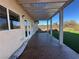 Covered patio with patterned concrete pad overlooking backyard with artificial turf at 2710 Mustang Pass St, Laughlin, NV 89029