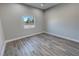 Bright bedroom with gray vinyl flooring and a window at 2750 Zephyr Ave, Pahrump, NV 89048