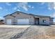 Newly constructed home with a two-car garage and desert landscaping at 2750 Zephyr Ave, Pahrump, NV 89048