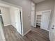 Bright hallway with wood-look floors and linen closet at 2750 Zephyr Ave, Pahrump, NV 89048