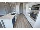 Modern kitchen with white cabinets, quartz countertops, and stainless steel appliances at 2750 Zephyr Ave, Pahrump, NV 89048