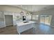 Bright kitchen featuring white cabinets, quartz island, and sliding glass door to patio at 2750 Zephyr Ave, Pahrump, NV 89048