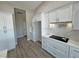 White kitchen cabinets and countertops, and a view down a hallway at 2750 Zephyr Ave, Pahrump, NV 89048