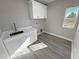 Laundry room with white cabinets and quartz countertop at 2750 Zephyr Ave, Pahrump, NV 89048