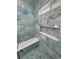 Walk-in shower with marble tile and built-in shelves at 2750 Zephyr Ave, Pahrump, NV 89048