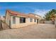 Home's rear exterior shows patio, brick wall, and desert landscape features at 5217 Yellow Dawn Ct, Las Vegas, NV 89130