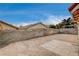 Spacious backyard featuring a brick-paved patio, block wall fencing, and clear blue skies at 5217 Yellow Dawn Ct, Las Vegas, NV 89130