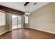 Open dining room featuring wood floors, neutral paint, sliding glass doors, and backyard access at 5217 Yellow Dawn Ct, Las Vegas, NV 89130