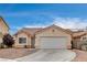 Charming single-story home with a tile roof, paved driveway, and low-maintenance desert landscaping at 5217 Yellow Dawn Ct, Las Vegas, NV 89130