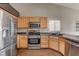 A close up of a kitchen featuring stainless steel appliances and light wood cabinetry at 5217 Yellow Dawn Ct, Las Vegas, NV 89130