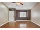 Bright living room featuring wood floors, neutral paint, large windows, and a ceiling fan at 5217 Yellow Dawn Ct, Las Vegas, NV 89130