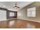 Bright living room featuring wood floors, neutral paint, large windows, and a ceiling fan at 5217 Yellow Dawn Ct, Las Vegas, NV 89130