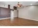 Spacious living room featuring wood floors, a ceiling fan, neutral paint, and an open floor plan at 5217 Yellow Dawn Ct, Las Vegas, NV 89130