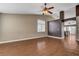 Spacious living room featuring wood floors, a ceiling fan, neutral paint, and lots of natural light at 5217 Yellow Dawn Ct, Las Vegas, NV 89130