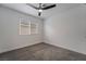 Well-lit bedroom featuring gray carpet and a ceiling fan at 303 Vallarte Dr, Henderson, NV 89014