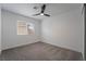 Bright bedroom with ceiling fan, gray carpet, and window coverings at 303 Vallarte Dr, Henderson, NV 89014