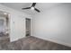 Light and airy bedroom with ceiling fan, gray carpet, and built-in shelving at 303 Vallarte Dr, Henderson, NV 89014