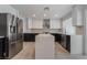 Modern kitchen with stainless steel appliances and white quartz countertops at 303 Vallarte Dr, Henderson, NV 89014