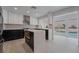 Open concept kitchen with island, stainless steel appliances, and view of the pool at 303 Vallarte Dr, Henderson, NV 89014