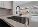 Modern kitchen sink with a black gooseneck faucet and white quartz countertops at 303 Vallarte Dr, Henderson, NV 89014