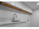 Laundry room with white cabinets, quartz countertops, and stainless steel sink at 303 Vallarte Dr, Henderson, NV 89014