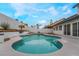 Stunning kidney-shaped pool with flagstone patio and lush landscaping at 303 Vallarte Dr, Henderson, NV 89014