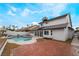 Inviting kidney-shaped pool with flagstone patio and surrounding landscaping at 303 Vallarte Dr, Henderson, NV 89014