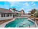 Refreshing kidney-shaped pool, flagstone patio, and backyard views at 303 Vallarte Dr, Henderson, NV 89014