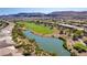 Aerial view of community with golf course, lake, and homes at 4414 Regalo Bello St, Las Vegas, NV 89135