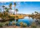 Scenic lake view with palm trees and a golf course at 4414 Regalo Bello St, Las Vegas, NV 89135