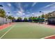 Well-maintained tennis court with seating and lighting at 4414 Regalo Bello St, Las Vegas, NV 89135