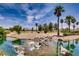 Serene water feature with a waterfall, surrounded by palm trees and landscaping at 4414 Regalo Bello St, Las Vegas, NV 89135