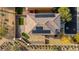 Aerial view of a home with tile roof, solar panels, putting green, and xeriscaped backyard in a residential community at 7579 Harwich Bay Ave, Las Vegas, NV 89179